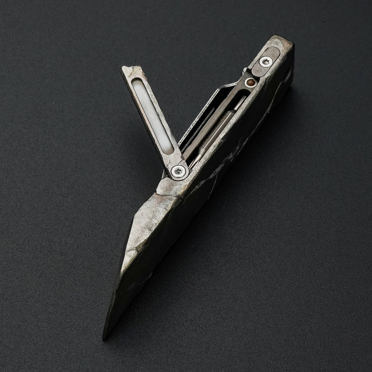MecArmy RL4-HC hand-carved titanium EDC pry bar with cracked texture shown open with the integrated tool compartment
