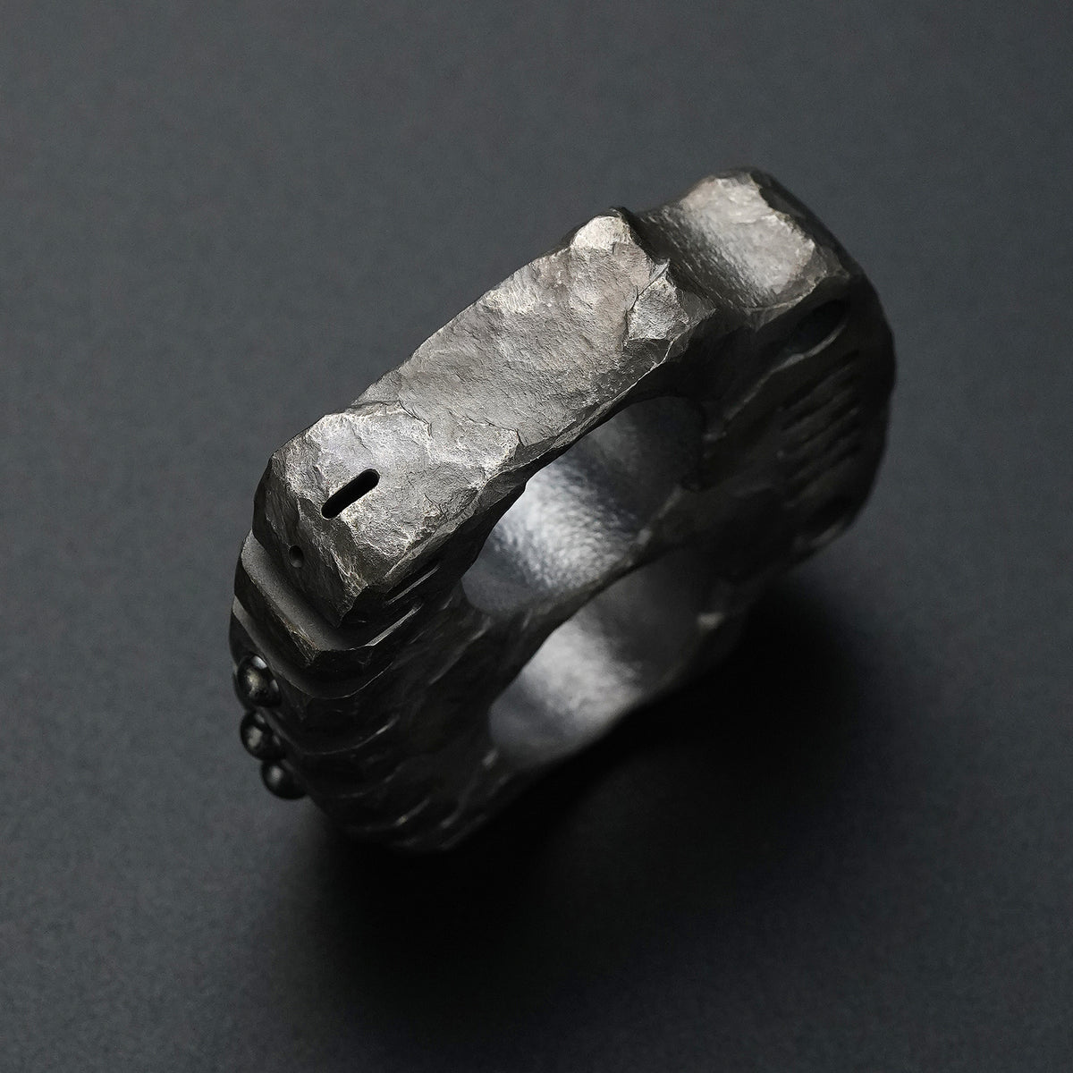 Top detail of the MecArmy TKF-HC hand-carved titanium EDC knuckle showing individually sculpted titanium facets