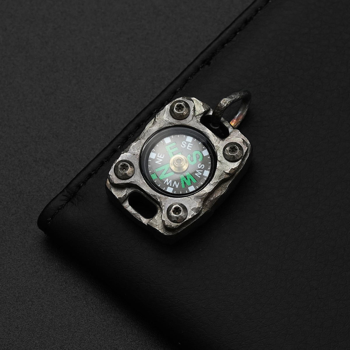 Front view of the MecArmy CMP2-HC hand-carved titanium EDC compass with one-of-a-kind sculpted titanium texture
