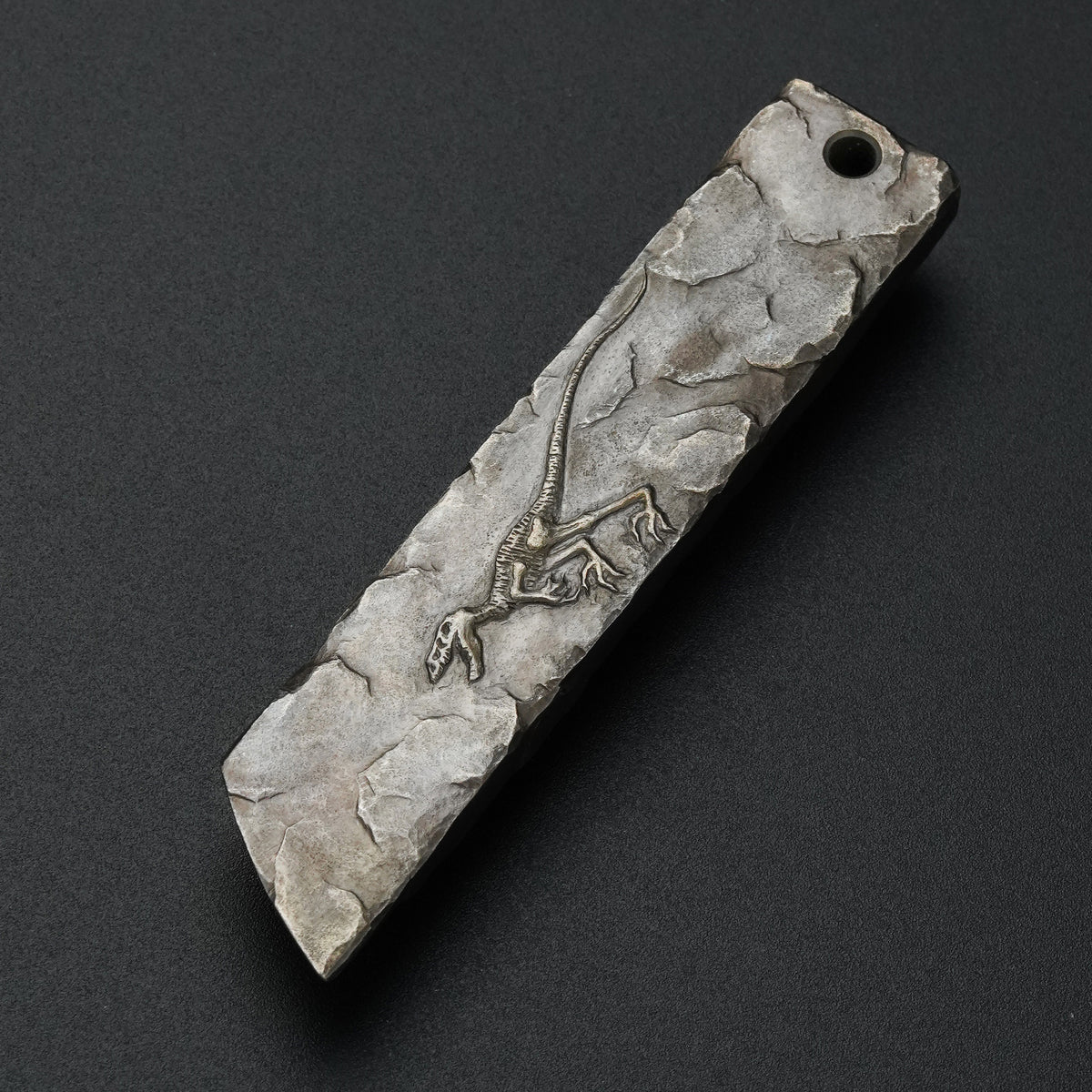 MecArmy RL4-HC hand-carved titanium EDC pry bar featuring a unique dinosaur skull carving on the sculpted titanium surface