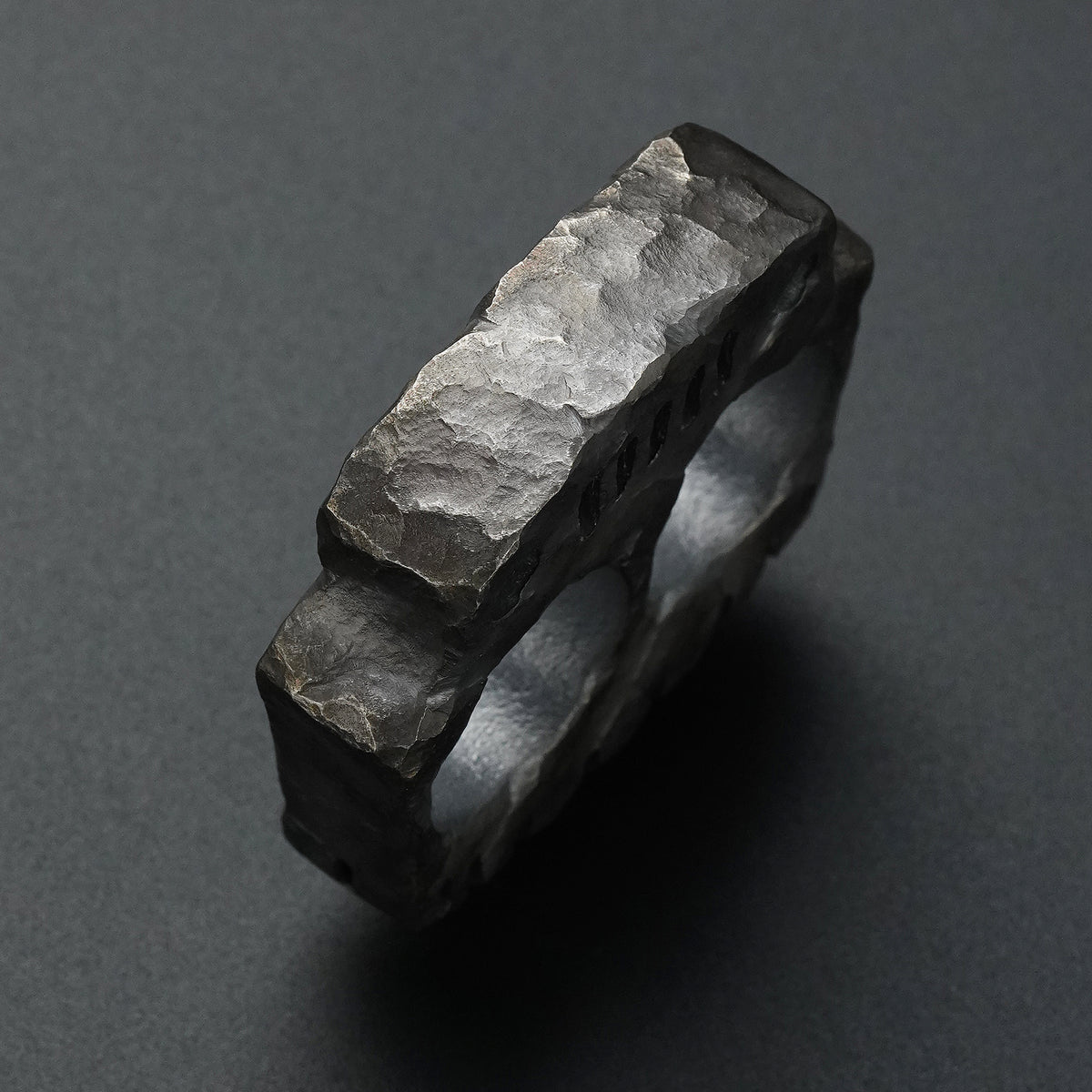 Side detail of the MecArmy TKF-HC hand-carved titanium EDC knuckle featuring a unique hand-sculpted finish
